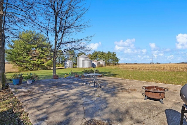 view of patio / terrace with a rural view and an outdoor fire pit