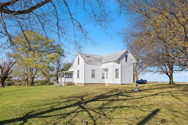 view of side of property with a lawn