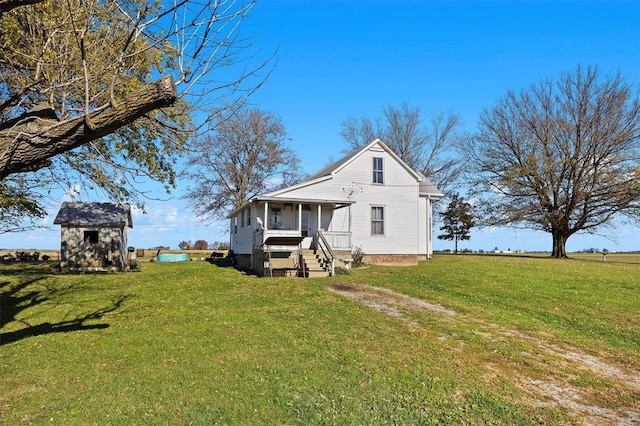 view of front of property featuring a porch, a storage unit, and a front lawn