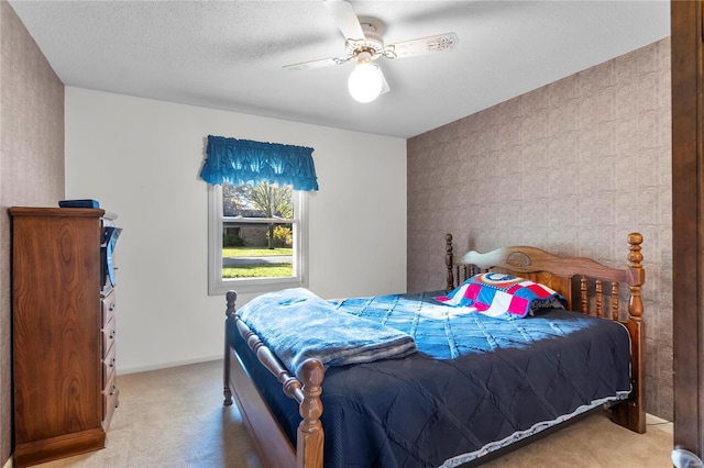 carpeted bedroom with a textured ceiling and ceiling fan