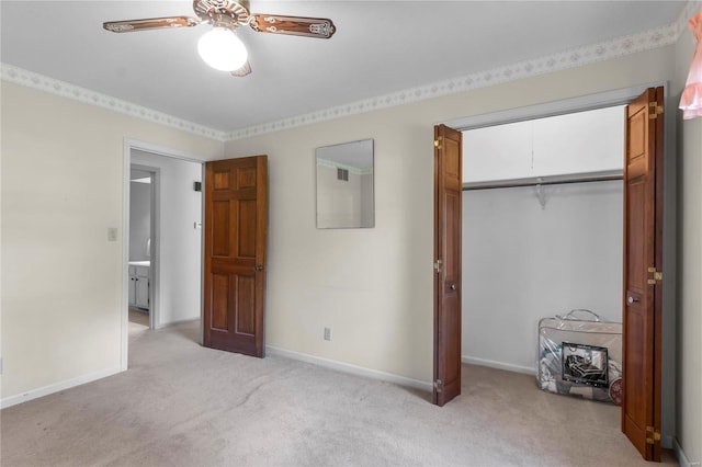 unfurnished bedroom featuring ceiling fan, a closet, and light colored carpet