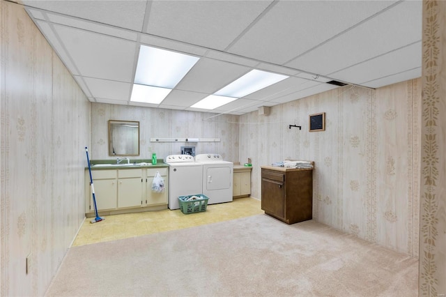 laundry room featuring cabinets, independent washer and dryer, light carpet, and sink