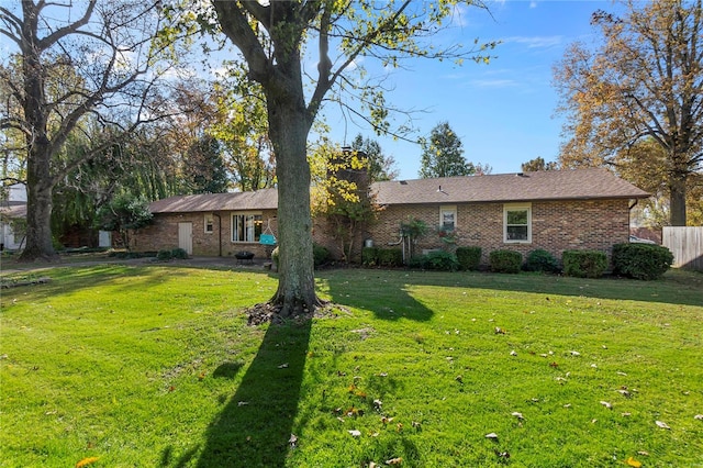 rear view of property with a yard