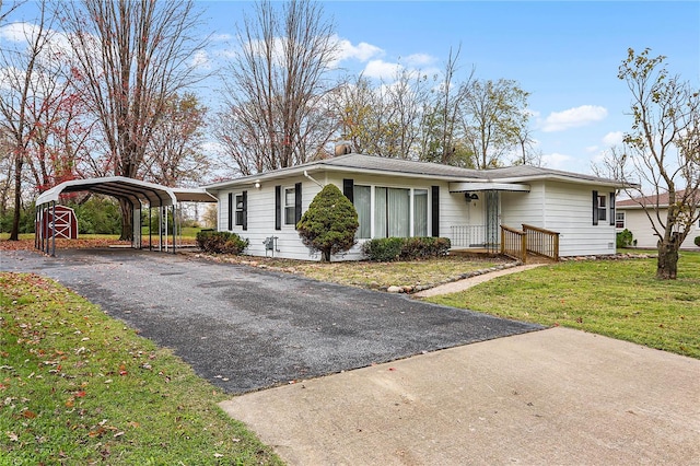 ranch-style home featuring a front lawn and a carport