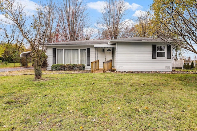 ranch-style house with a carport and a front lawn