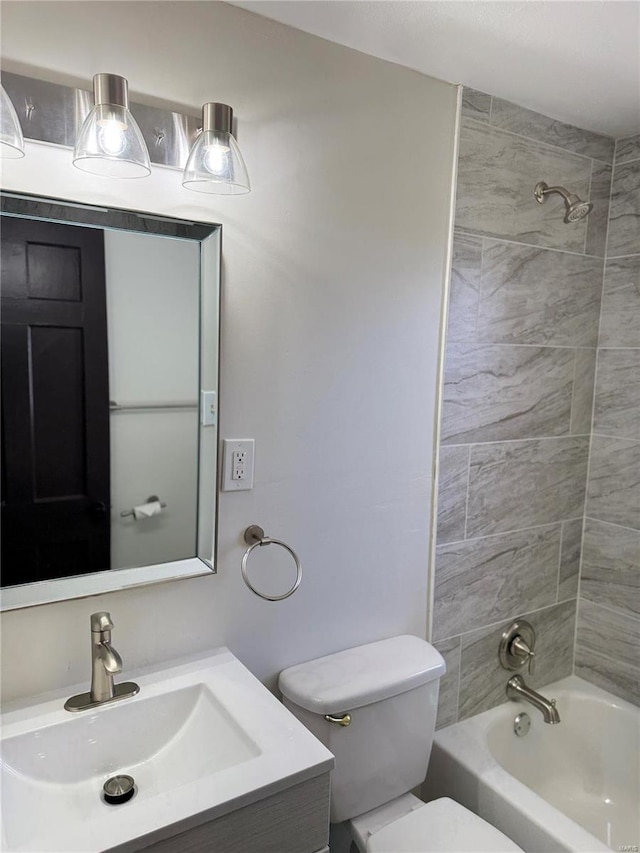 full bathroom with tiled shower / bath combo, toilet, and vanity