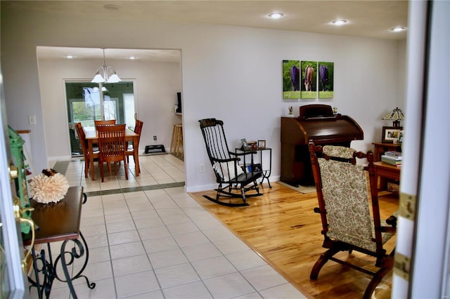 living room featuring an inviting chandelier and light hardwood / wood-style flooring