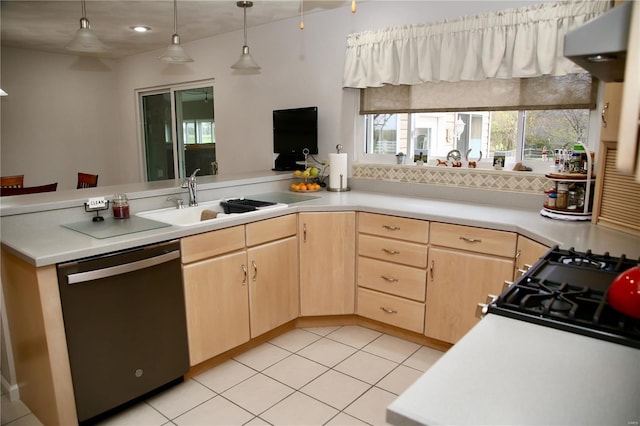 kitchen featuring light brown cabinets, sink, stainless steel dishwasher, pendant lighting, and light tile patterned floors