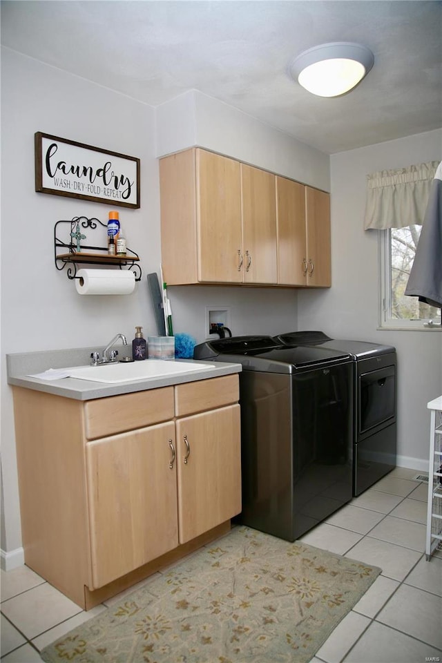 clothes washing area featuring cabinets, washing machine and dryer, sink, and light tile patterned flooring