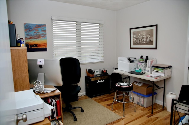 home office with light hardwood / wood-style floors