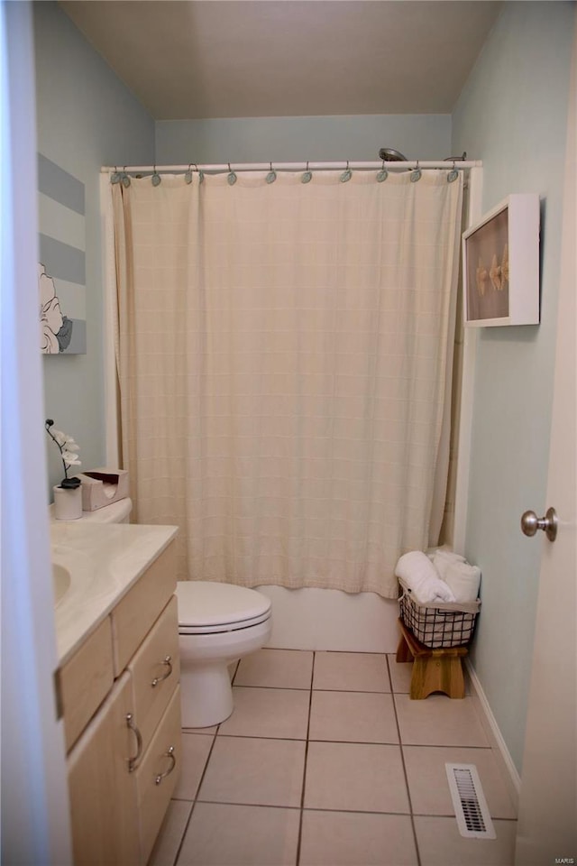 full bathroom with tile patterned floors, shower / tub combo with curtain, vanity, and toilet