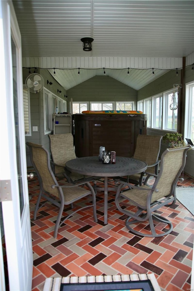 sunroom / solarium featuring vaulted ceiling