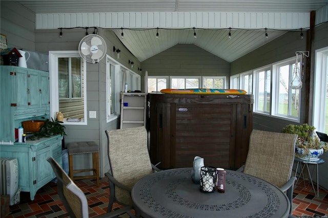 sunroom / solarium featuring vaulted ceiling