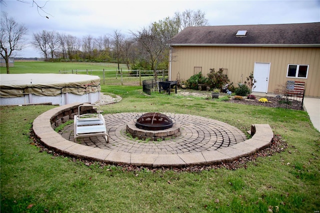 view of yard featuring a covered pool and an outdoor fire pit