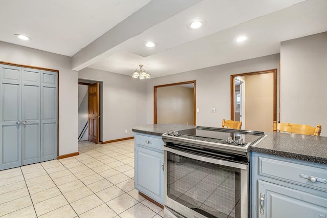 kitchen with dark countertops, stainless steel electric range, baseboards, and recessed lighting