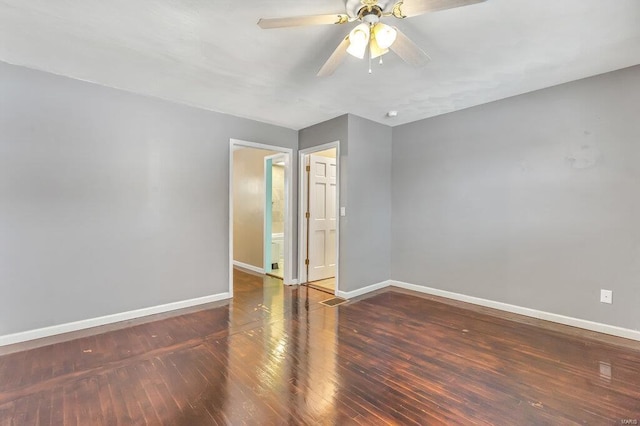 spare room featuring a ceiling fan, baseboards, and wood finished floors