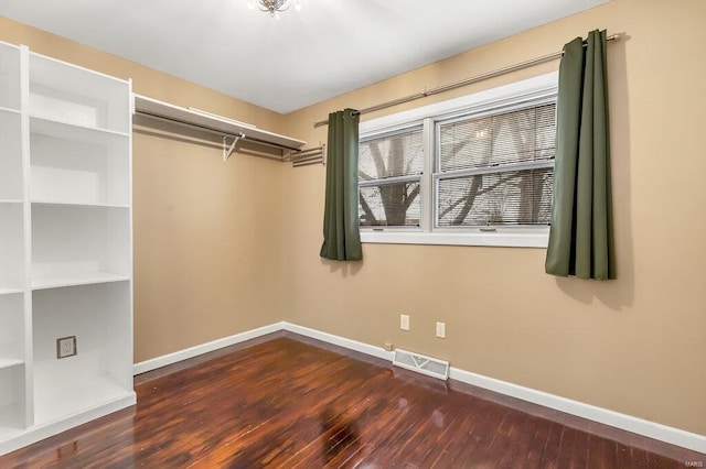 walk in closet with visible vents and wood finished floors