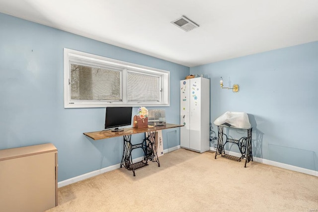 carpeted office space featuring visible vents and baseboards