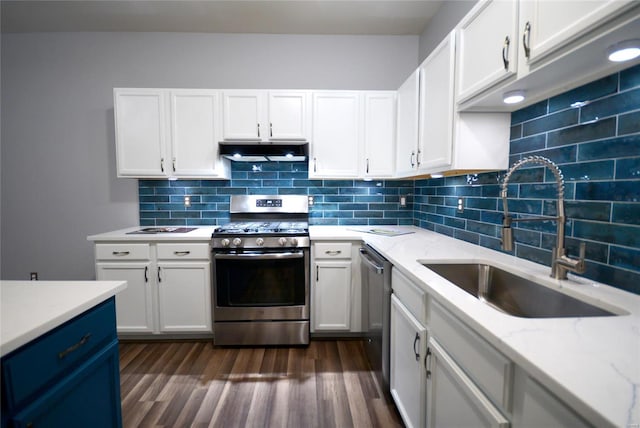 kitchen featuring appliances with stainless steel finishes, white cabinetry, and sink