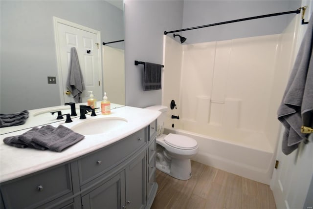 full bathroom featuring vanity, shower / bath combination, and toilet