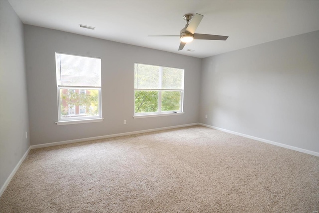 carpeted spare room with ceiling fan