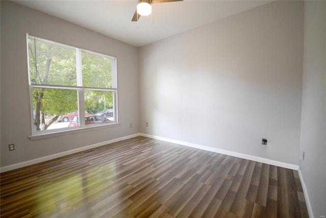 empty room featuring ceiling fan and dark wood-type flooring