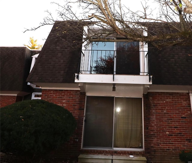 view of side of home with a balcony