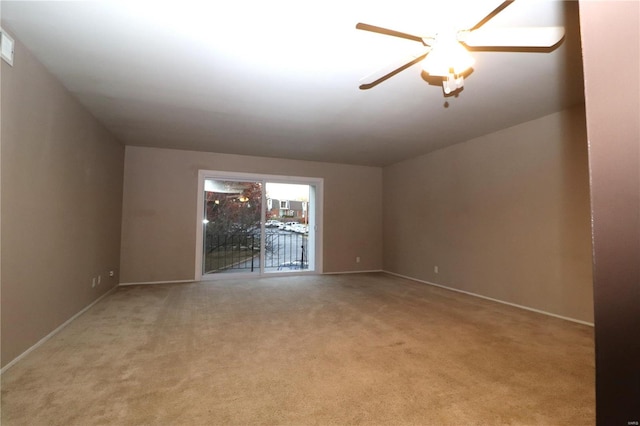 spare room with ceiling fan and light colored carpet