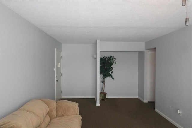 carpeted living room featuring a textured ceiling