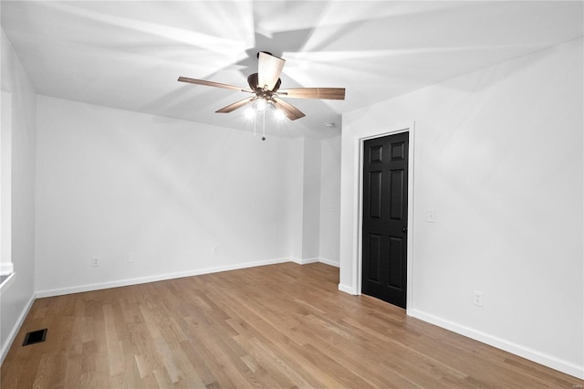 spare room featuring ceiling fan and light hardwood / wood-style floors