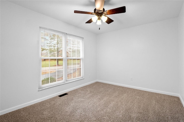 carpeted spare room featuring ceiling fan