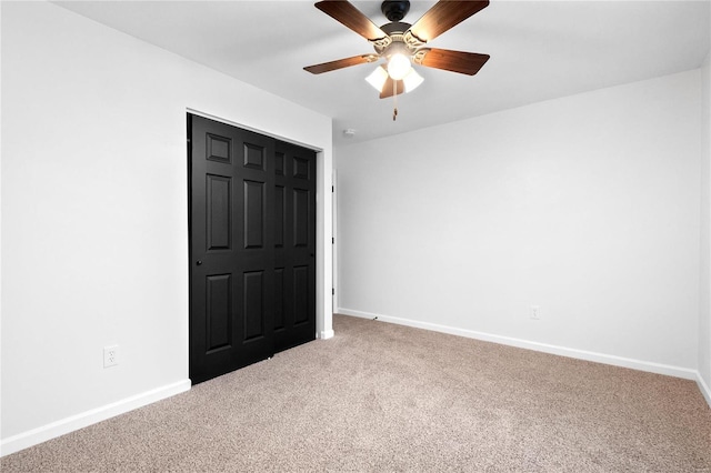 unfurnished bedroom featuring carpet flooring, ceiling fan, and a closet