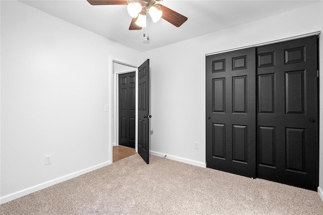 unfurnished bedroom featuring carpet flooring, ceiling fan, and a closet