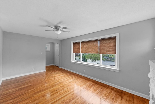 empty room with light hardwood / wood-style flooring and ceiling fan