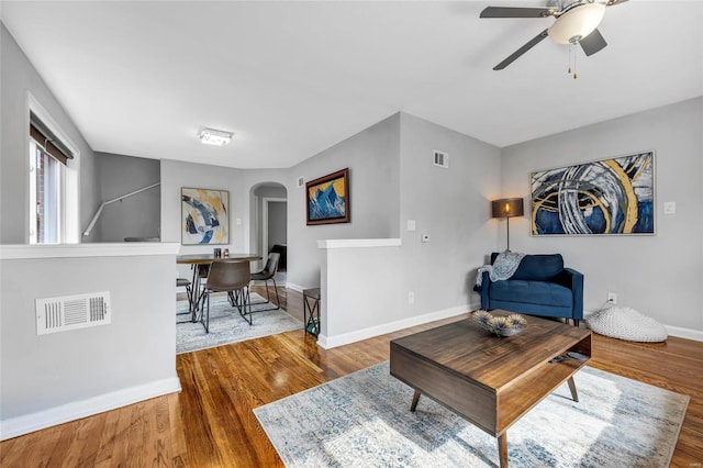 living room featuring ceiling fan and wood-type flooring