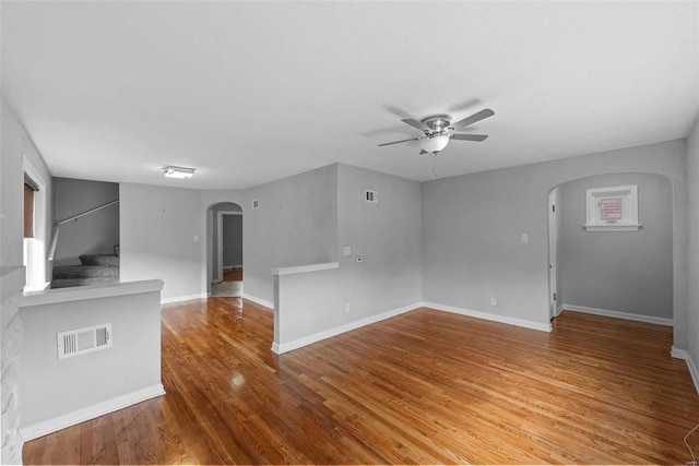 unfurnished living room with ceiling fan and hardwood / wood-style floors