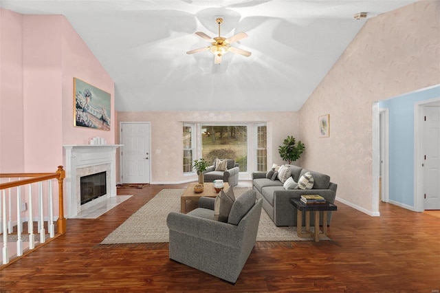 living room featuring a fireplace, ceiling fan, dark hardwood / wood-style flooring, and high vaulted ceiling