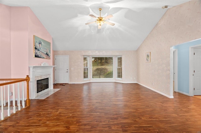 unfurnished living room with a fireplace, wood-type flooring, high vaulted ceiling, and ceiling fan