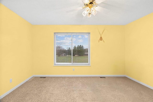 unfurnished room featuring carpet, ceiling fan, and a textured ceiling