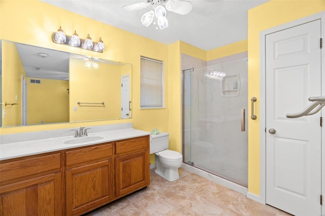 bathroom with a textured ceiling, ceiling fan, toilet, and walk in shower