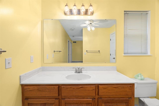 bathroom featuring vanity, ceiling fan, and toilet