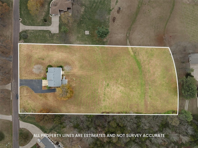 birds eye view of property with a rural view