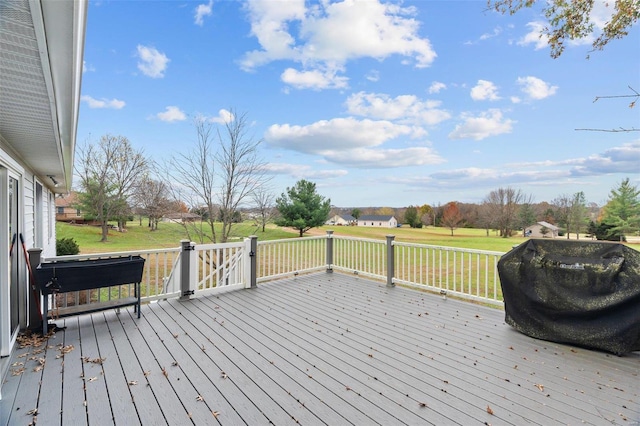 wooden deck featuring a lawn