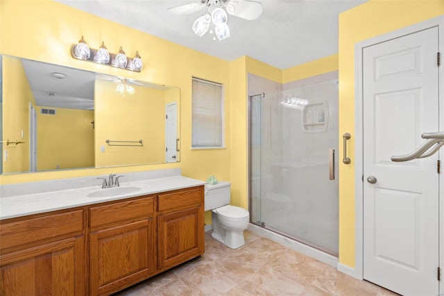 bathroom featuring toilet, visible vents, a ceiling fan, a shower stall, and vanity