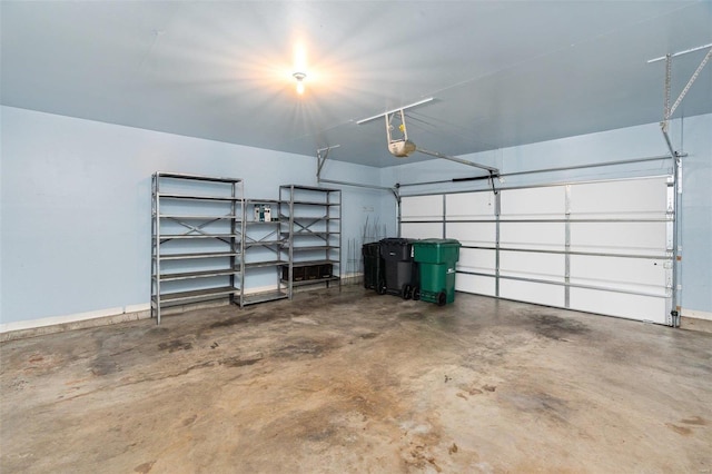 garage with baseboards and a garage door opener