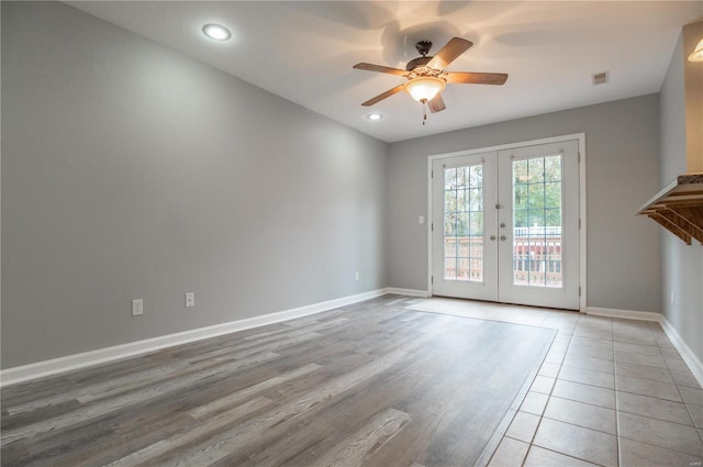 unfurnished room featuring ceiling fan, light hardwood / wood-style floors, and french doors