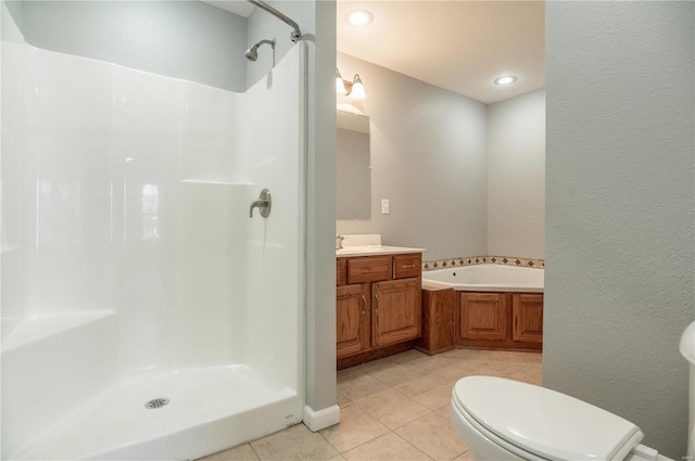 full bathroom featuring tile patterned floors, vanity, shower with separate bathtub, and toilet