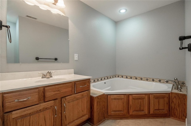 bathroom featuring a bathing tub, vanity, and tile patterned floors