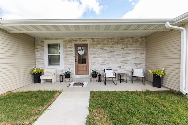 doorway to property featuring a yard