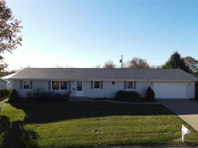 single story home featuring a garage and a front lawn